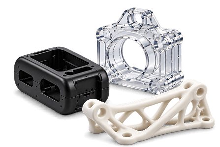 Prototype 3D printed parts including clear resin, black housing, and lattice bracket
